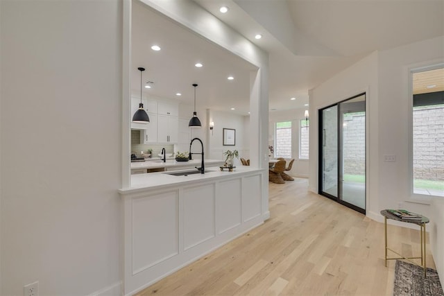 6516 NE 97th St, Oklahoma City, OK 73151 - kitchen featuring white cabinetry, light countertops, light wood-type flooring, recessed lighting, and hanging light fixtures