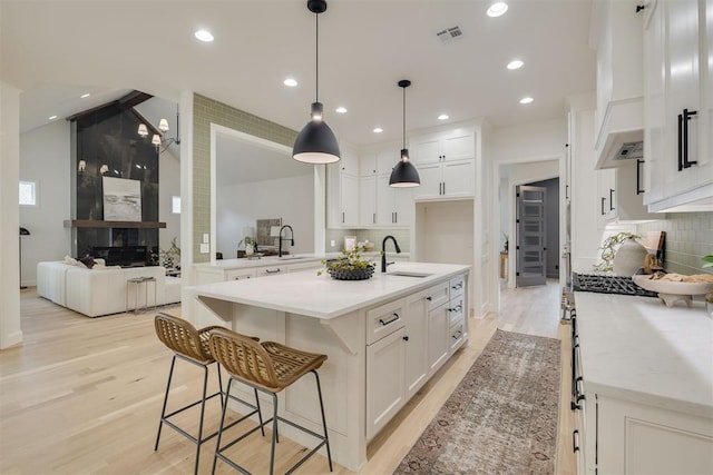 6516 NE 97th St, Oklahoma City, OK 73151 - kitchen featuring light wood-style flooring, custom exhaust hood, decorative backsplash, and recessed lighting