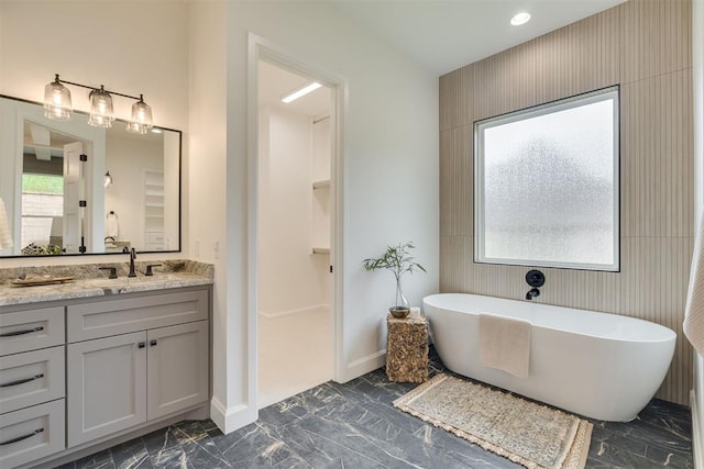 6516 NE 97th St, Oklahoma City, OK 73151 - bathroom featuring vanity, a freestanding tub, and marble finish floors