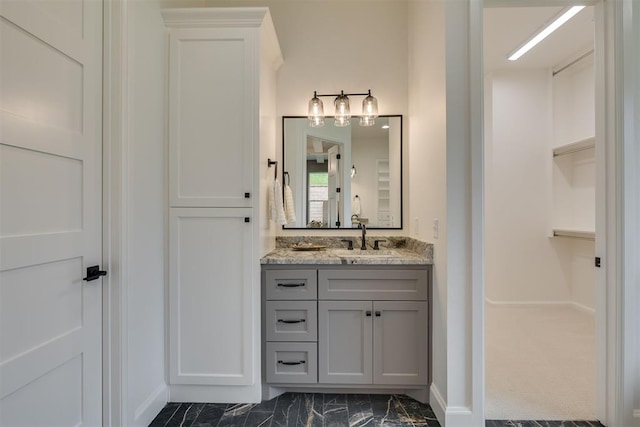 6516 NE 97th St, Oklahoma City, OK 73151 - bathroom featuring vanity, a spacious closet, and marble finish floors