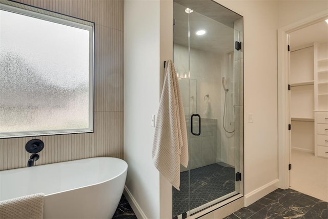 6516 NE 97th St, Oklahoma City, OK 73151 - full bathroom with marble finish flooring, a shower stall, a freestanding tub, and a spacious closet