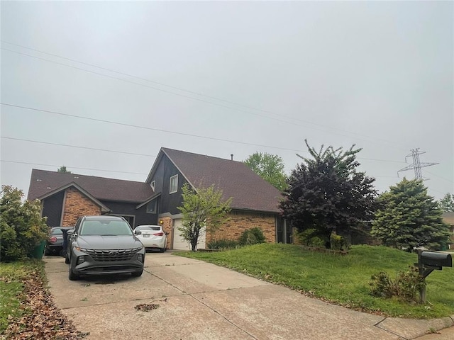 view of home's exterior featuring concrete driveway, brick siding, a lawn, and a garage