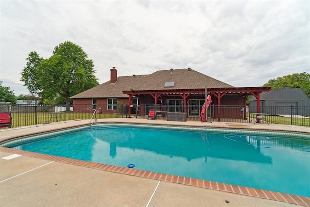 view of pool with fence and a patio area