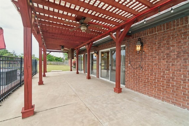 view of patio with ceiling fan, fence, and a pergola