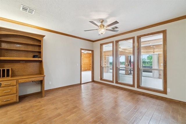 empty room with baseboards, ceiling fan, light wood-style flooring, crown molding, and an office area