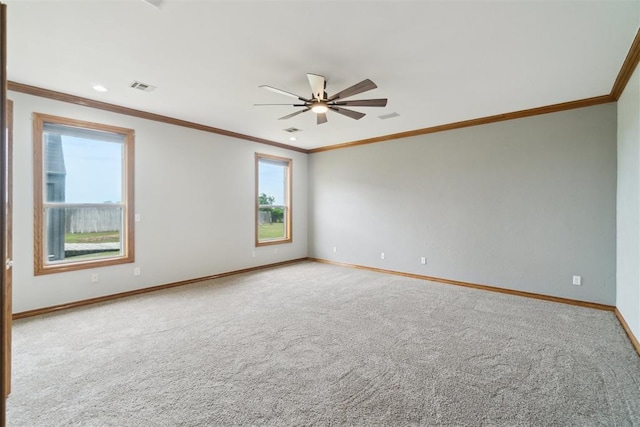 unfurnished room with baseboards, ceiling fan, carpet, and crown molding