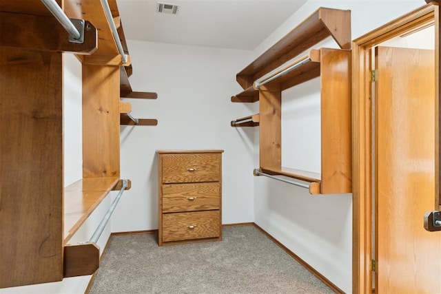 walk in closet with carpet floors