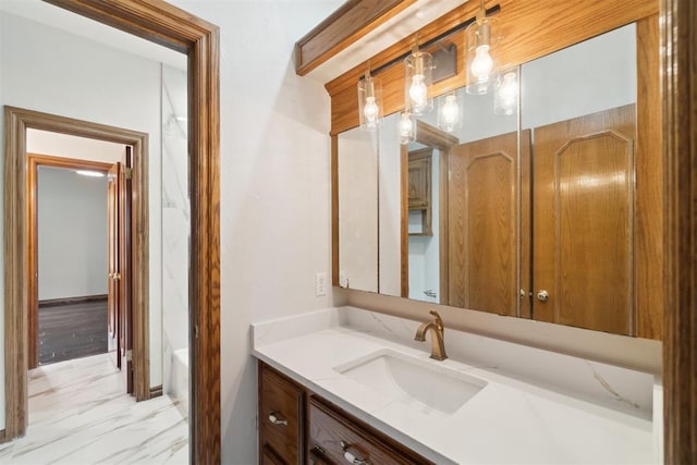 bathroom featuring vanity, marble look tiles, and a tub to relax in