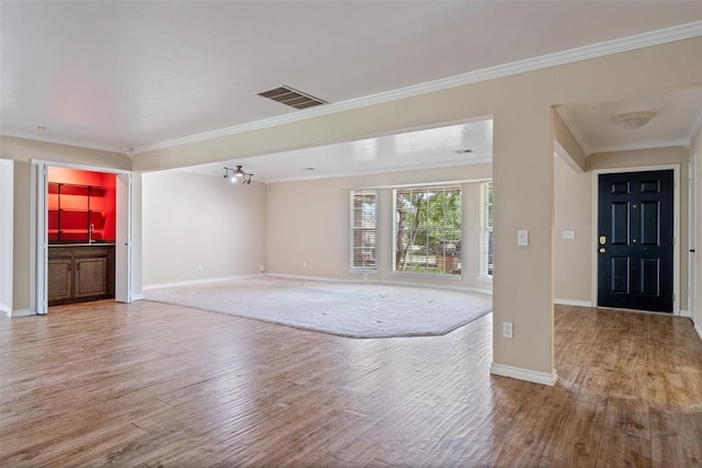 6408 Brentford Ter, Oklahoma City, OK 73132 - unfurnished living room with wood finished floors, crown molding, and baseboards