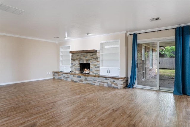 6408 Brentford Ter, Oklahoma City, OK 73132 - unfurnished living room with wood finished floors, crown molding, a stone fireplace, baseboards, and built in features