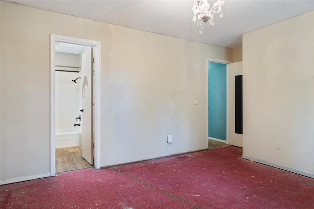 6408 Brentford Ter, Oklahoma City, OK 73132 - unfurnished bedroom featuring carpet floors, a chandelier, and ensuite bathroom