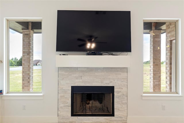 detailed view of ornate columns, baseboards, and a fireplace