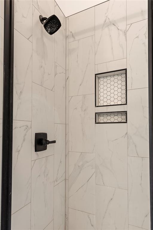 full bath featuring tiled shower
