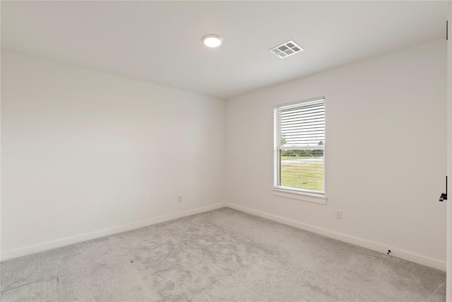 empty room with baseboards and light carpet