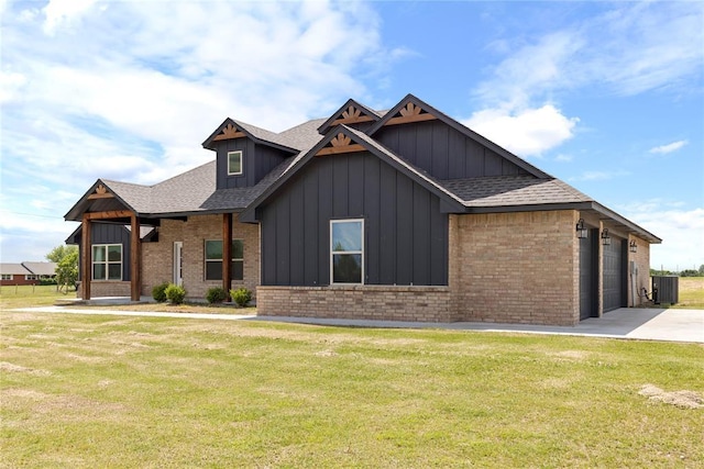 view of front facade with board and batten siding, brick siding, a front lawn, and a shingled roof