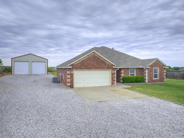 view of front of house with central AC, brick siding, a shingled roof, and a garage