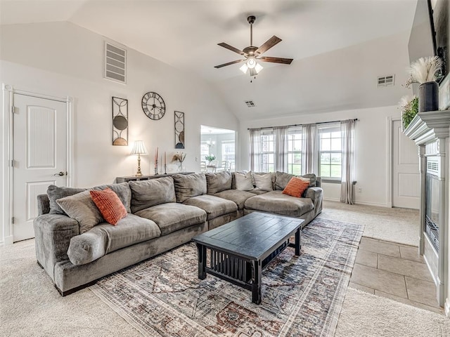 living room with vaulted ceiling, light carpet, ceiling fan, baseboards, and a glass covered fireplace