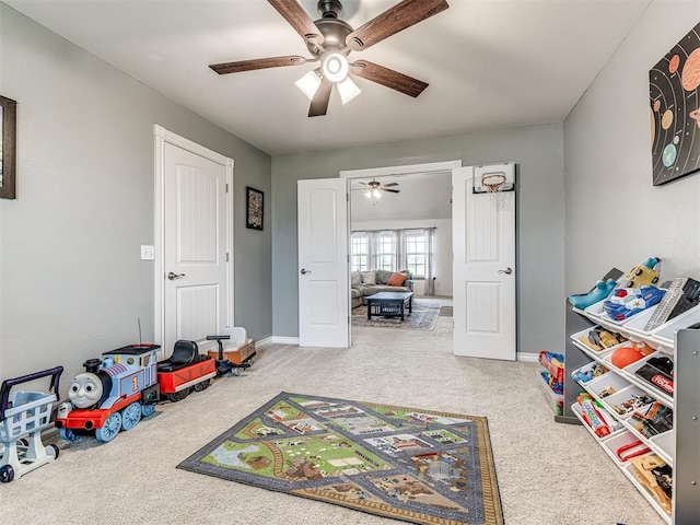recreation room featuring a ceiling fan, carpet, and baseboards