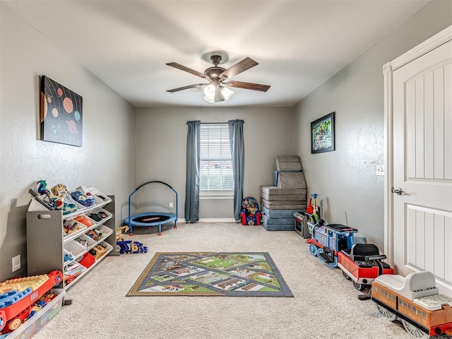 rec room featuring a ceiling fan, carpet, and baseboards
