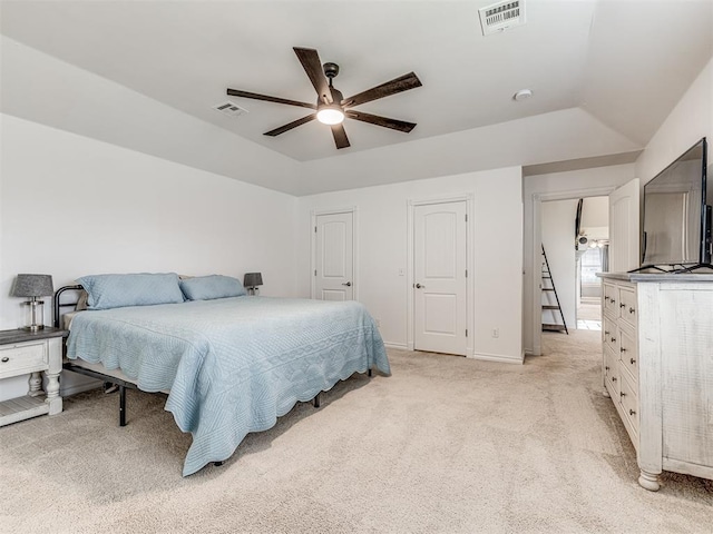 bedroom with light carpet, a ceiling fan, multiple closets, and baseboards