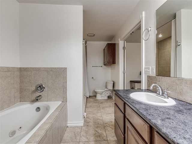 bathroom featuring a jetted tub, vanity, tile patterned flooring, baseboards, and toilet