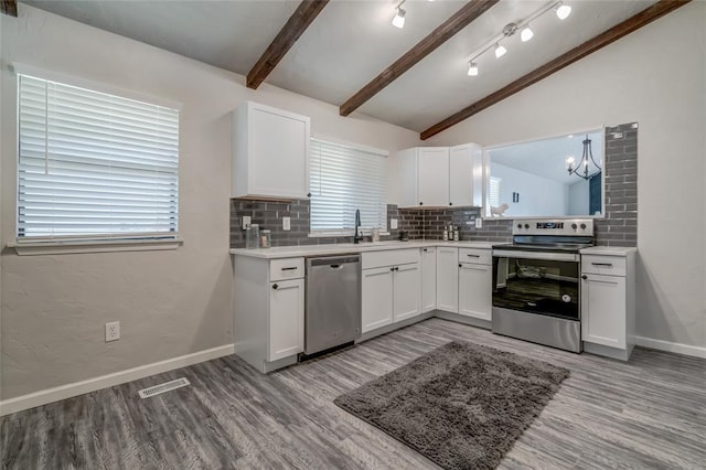 7301 Kings Manor Ct, Oklahoma City, OK 73132 - kitchen featuring stainless steel appliances, light wood finished floors, decorative backsplash, and white cabinets