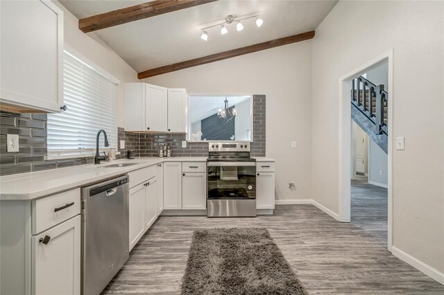 7301 Kings Manor Ct, Oklahoma City, OK 73132 - kitchen featuring stainless steel appliances, a sink, backsplash, light wood-type flooring, and white cabinets