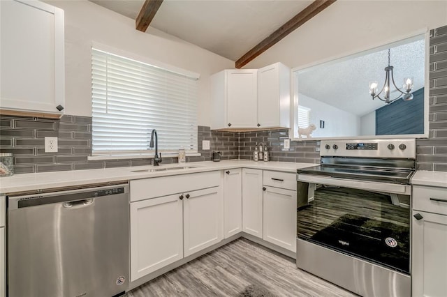 7301 Kings Manor Ct, Oklahoma City, OK 73132 - kitchen featuring appliances with stainless steel finishes, a sink, tasteful backsplash, a chandelier, and light wood-style floors
