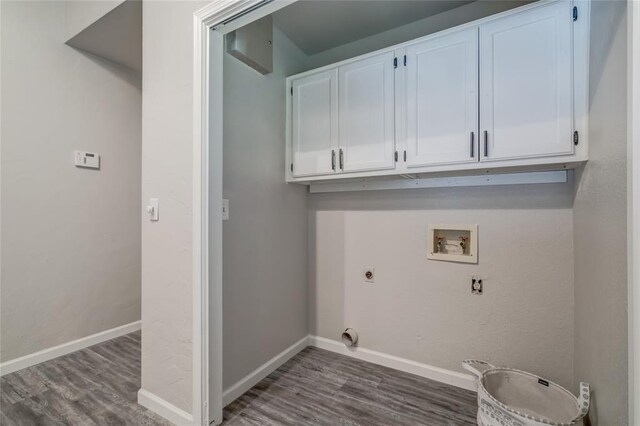 7301 Kings Manor Ct, Oklahoma City, OK 73132 - washroom with hookup for an electric dryer, hookup for a washing machine, cabinet space, and wood finished floors