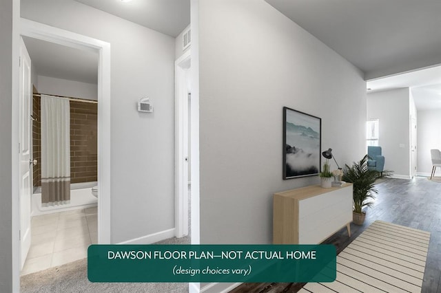 hall featuring baseboards and tile patterned floors