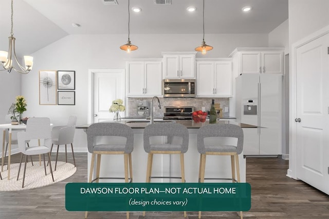 kitchen with stainless steel appliances, decorative backsplash, a kitchen bar, a sink, and lofted ceiling