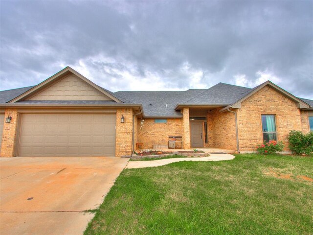 5702 Cedar Tree Cir, Guthrie, OK 73044 - view of front of property featuring brick siding, an attached garage, driveway, and a front lawn