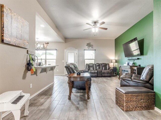 5702 Cedar Tree Cir, Guthrie, OK 73044 - living area featuring ceiling fan, wood finished floors, a chandelier, and baseboards