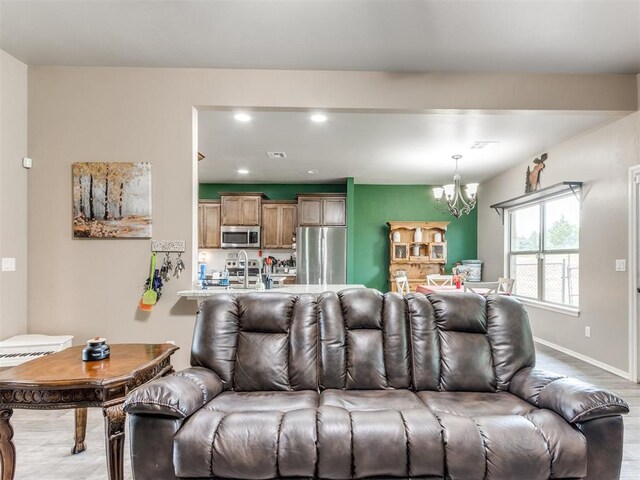 5702 Cedar Tree Cir, Guthrie, OK 73044 - living room with a chandelier, wood finished floors, recessed lighting, and baseboards