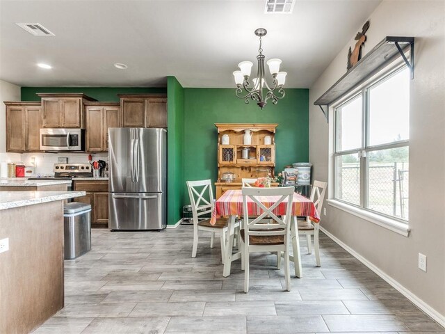 5702 Cedar Tree Cir, Guthrie, OK 73044 - dining area featuring baseboards, a chandelier, wood tiled floors, and recessed lighting