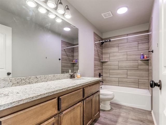 5702 Cedar Tree Cir, Guthrie, OK 73044 - full bathroom featuring vanity, toilet, bathtub / shower combination, and wood finished floors