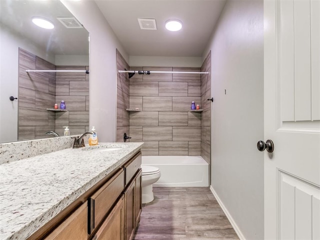 5702 Cedar Tree Cir, Guthrie, OK 73044 - bathroom with toilet, vanity, wood finished floors, tub / shower combination, and baseboards