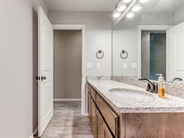 5702 Cedar Tree Cir, Guthrie, OK 73044 - bathroom featuring vanity, wood finished floors, and baseboards