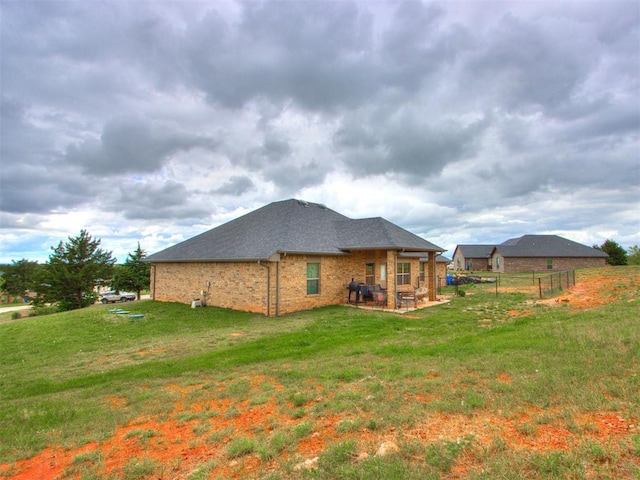 5702 Cedar Tree Cir, Guthrie, OK 73044 - back of house with a patio, brick siding, and roof with shingles