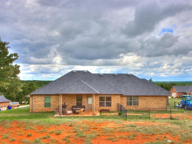 5702 Cedar Tree Cir, Guthrie, OK 73044 - rear view of house featuring a shingled roof, a patio area, and brick siding