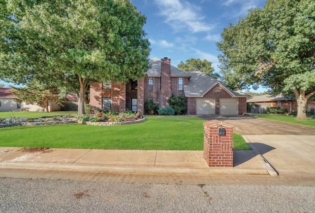 view of front of house with brick siding, driveway, a front lawn, and a chimney