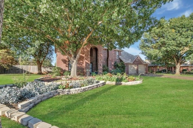 view of front of property featuring a garage, brick siding, and asphalt driveway