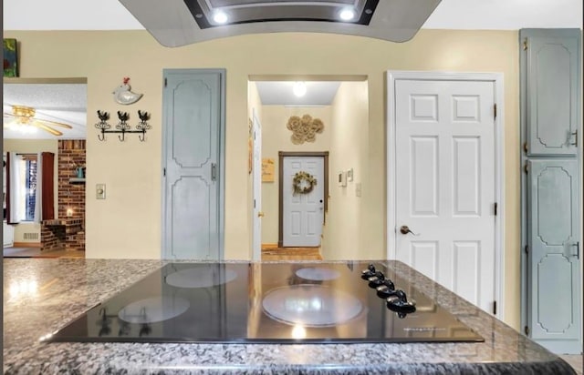 kitchen featuring black electric stovetop and stone countertops