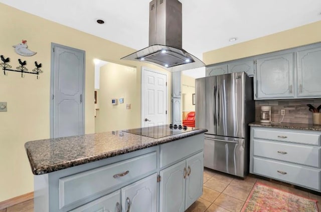 kitchen with freestanding refrigerator, island exhaust hood, black electric stovetop, and gray cabinets