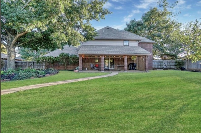 rear view of property featuring roof with shingles and brick siding