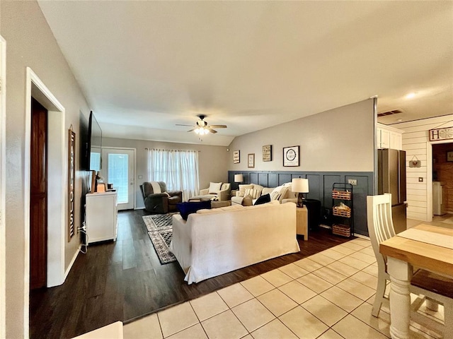 living room with ceiling fan and light tile patterned floors