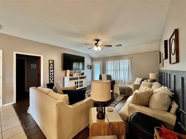 living room featuring a ceiling fan and baseboards