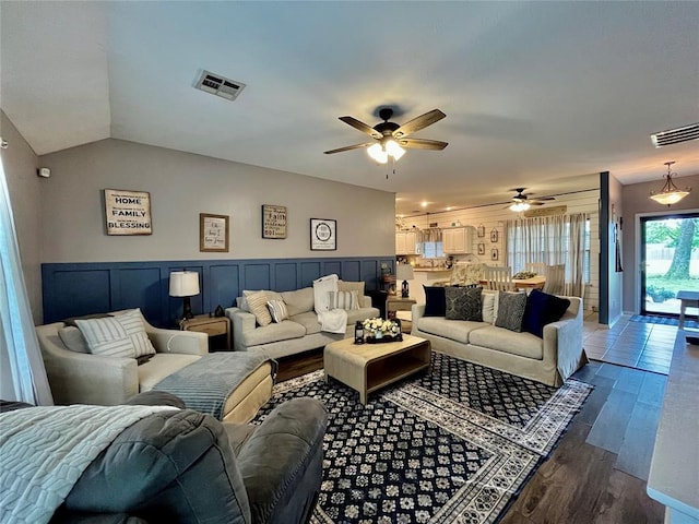 living room with a ceiling fan, dark wood-style floors, and lofted ceiling