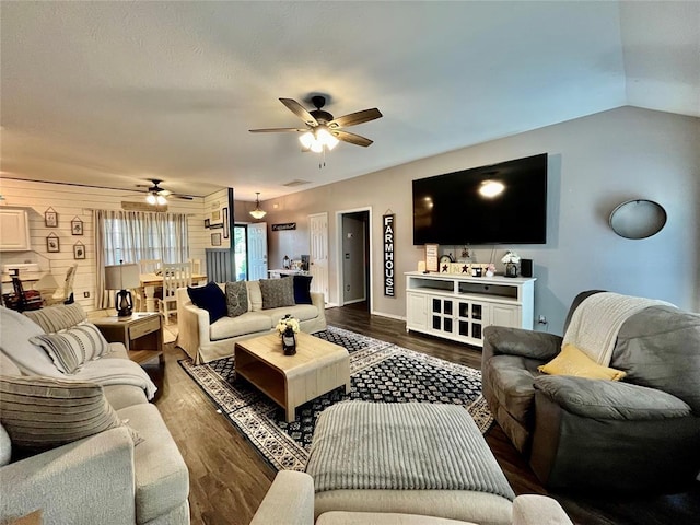 living room featuring a ceiling fan, dark wood-type flooring, and baseboards