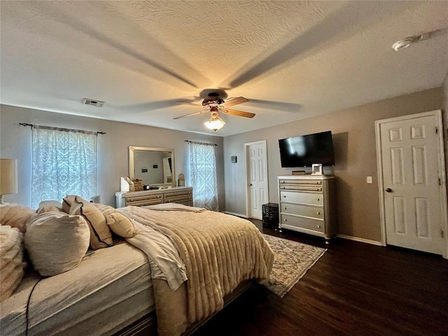 bedroom featuring dark wood-style floors, baseboards, and a ceiling fan